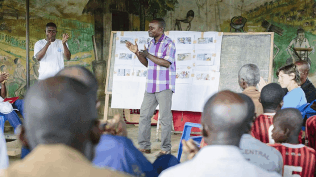 A man giving a presentation in the Democratic Republic of the Congo.