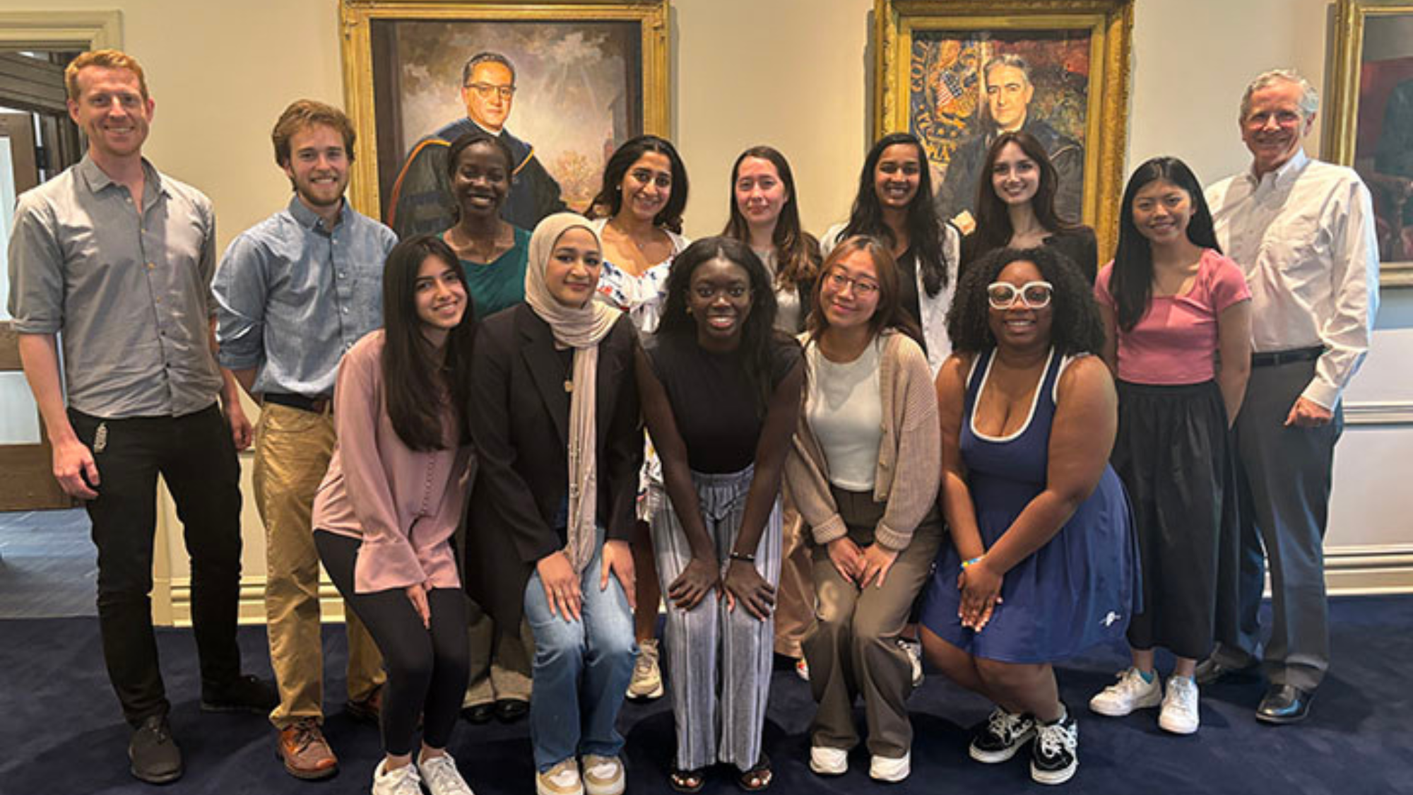 Spring 2024 Global Health Student Fellows pose for a photo with Global Health Institute Managing Director Dr. Oliver Johnson (left) and Senior Advisor John Monahan.