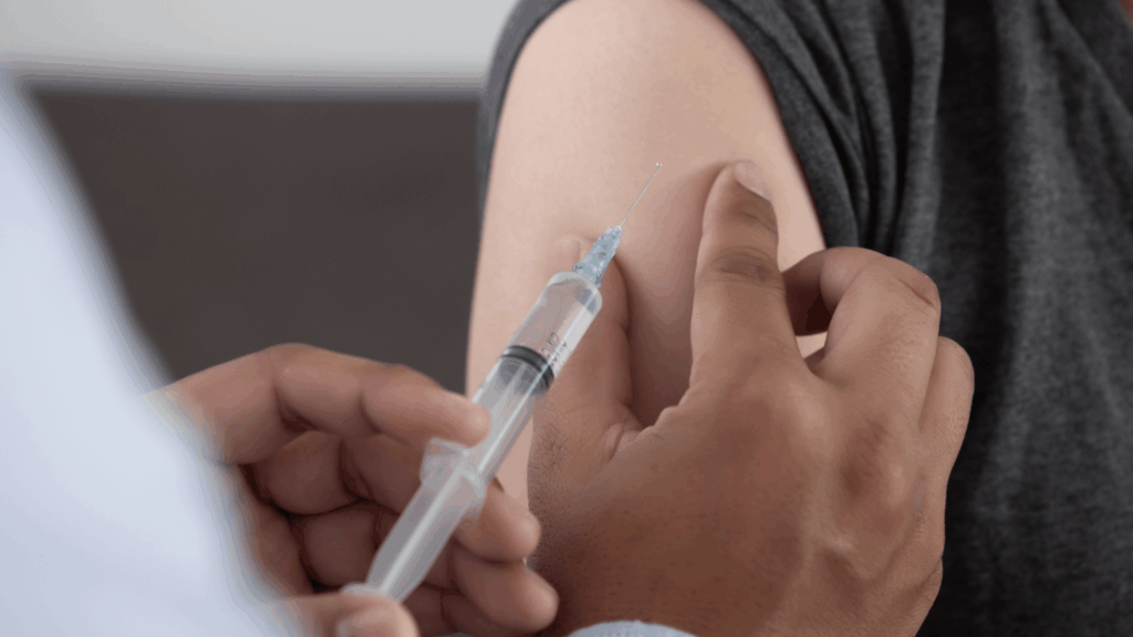 Close-up image of a young child receiving a vaccine shot.