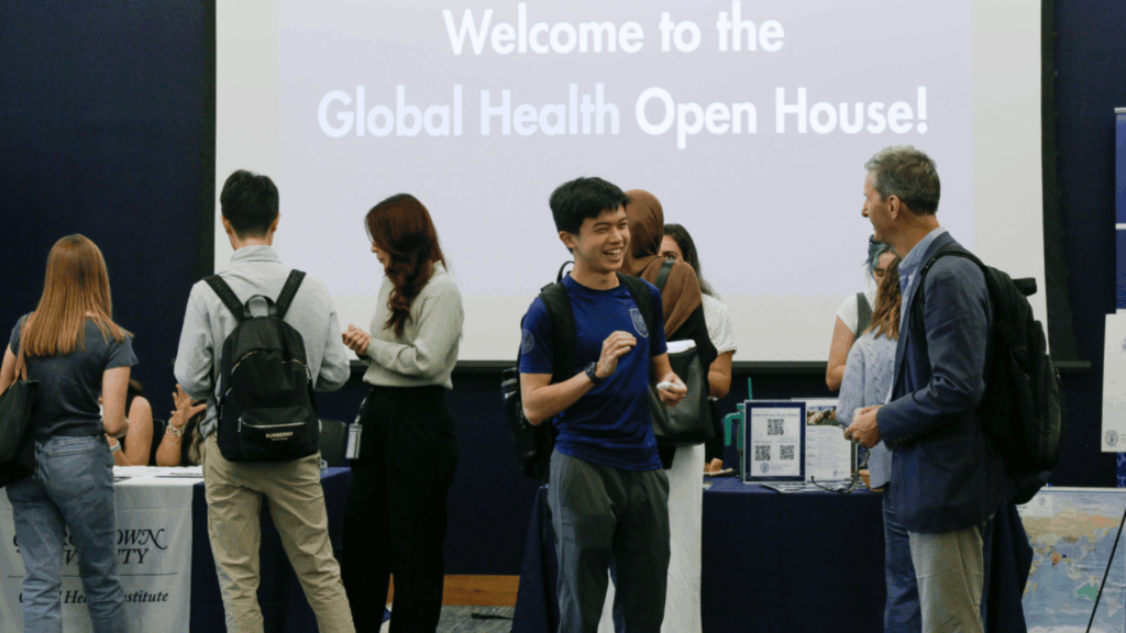 Georgetown community conversing and visiting tables at the annual Global Health Open House.
