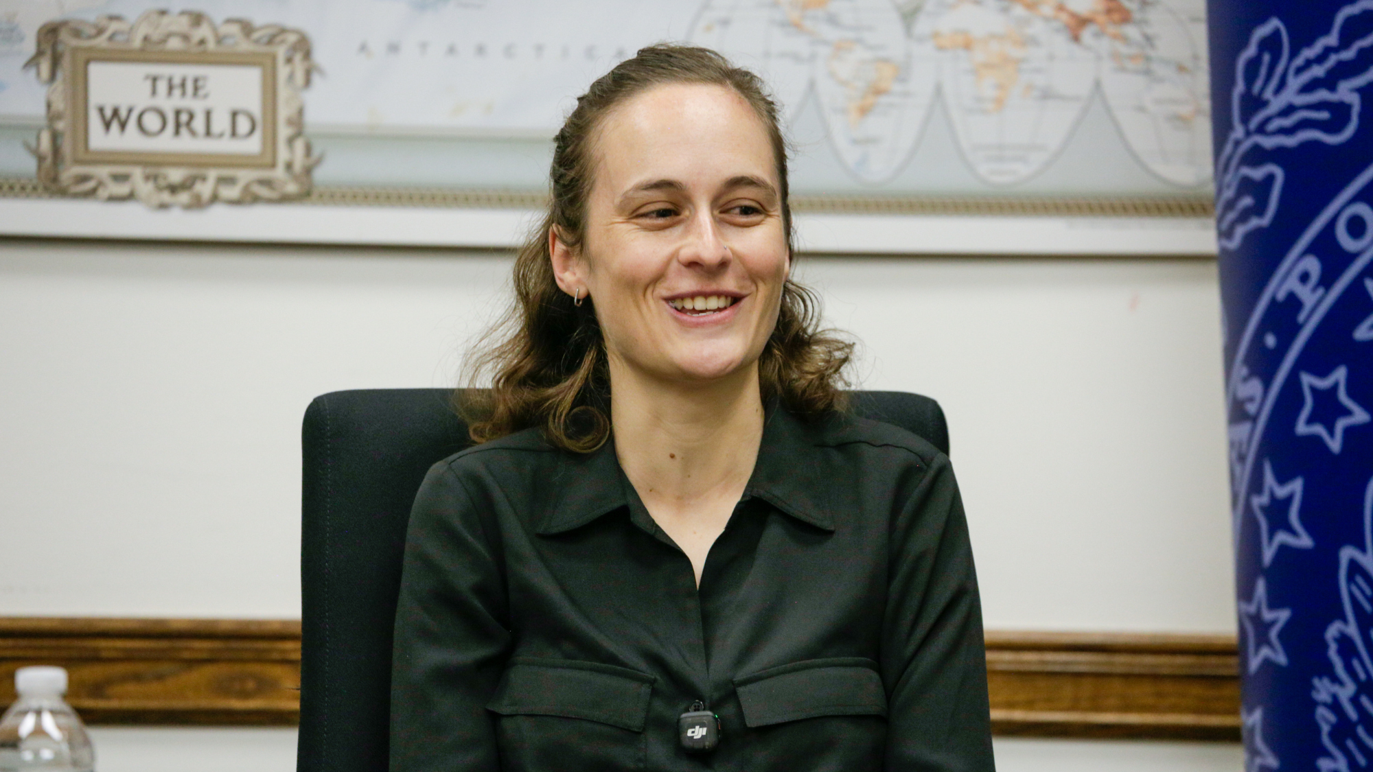 A woman smiling and speaking.