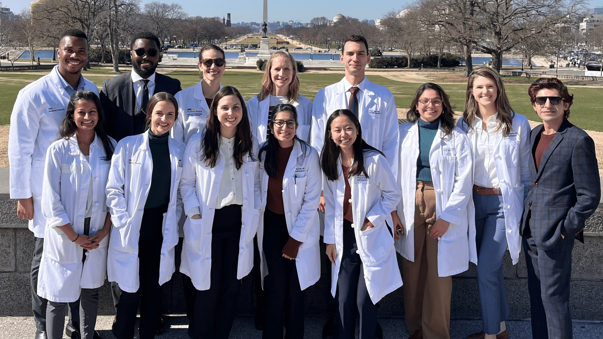 Members of the MedStar Health-Georgetown University Global Health Equity Track pose in front of the Washington Monument.