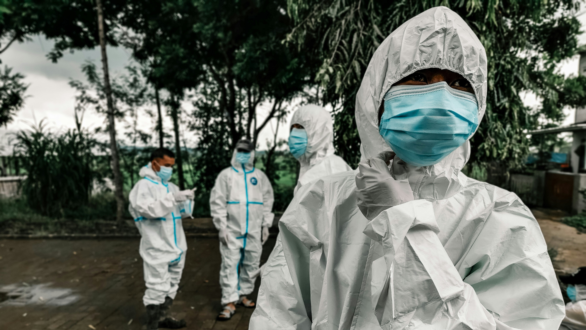 Healthcare workers in personal protective equipment.