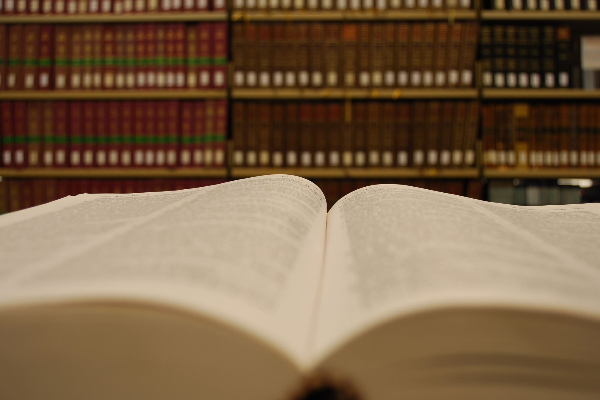 An open book with additional books in the background