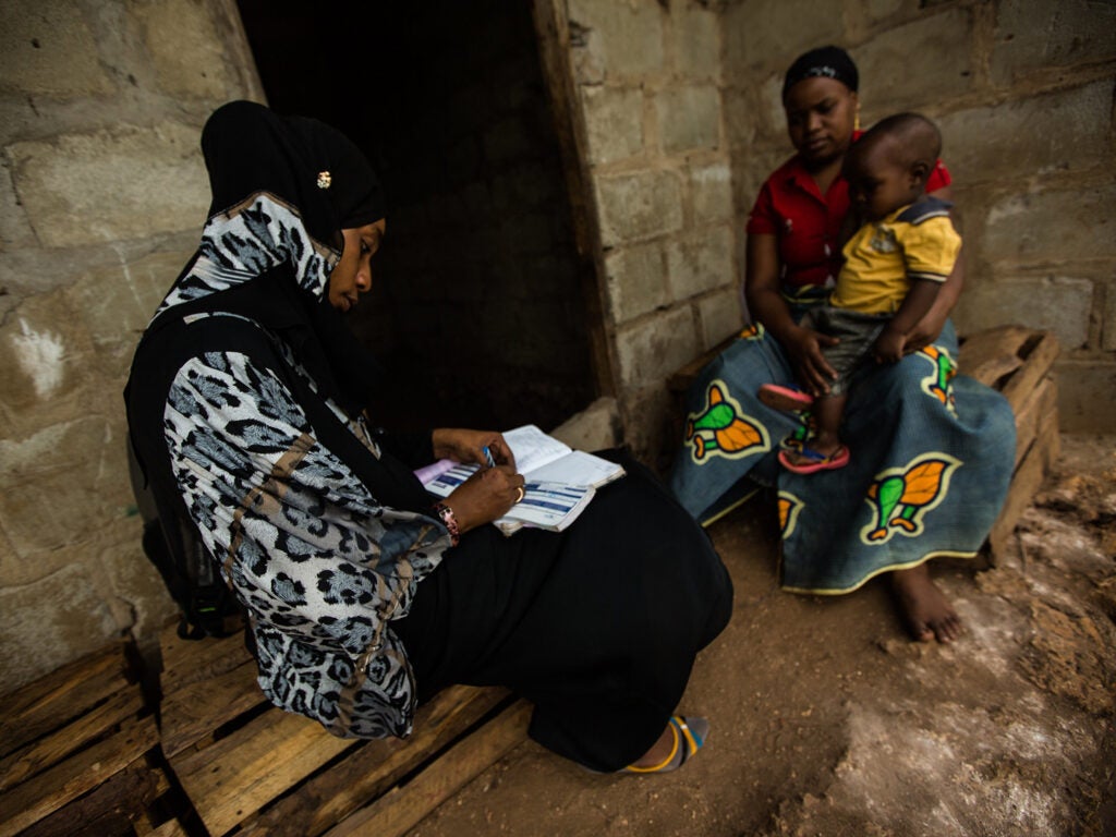 A health worker helps a mother and her child in Zanzibar.