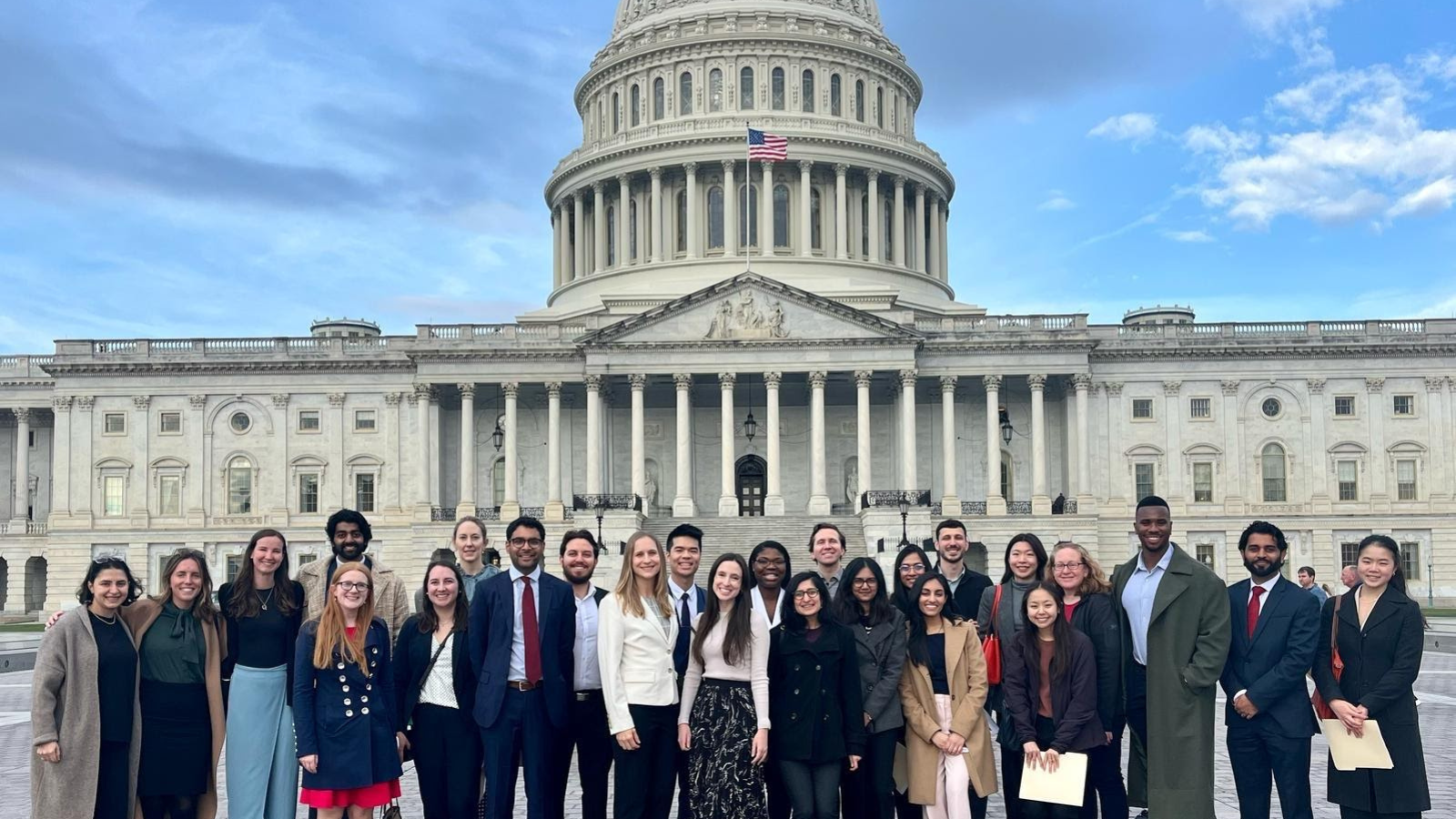 A group of student fellows in front of the Capitol building.