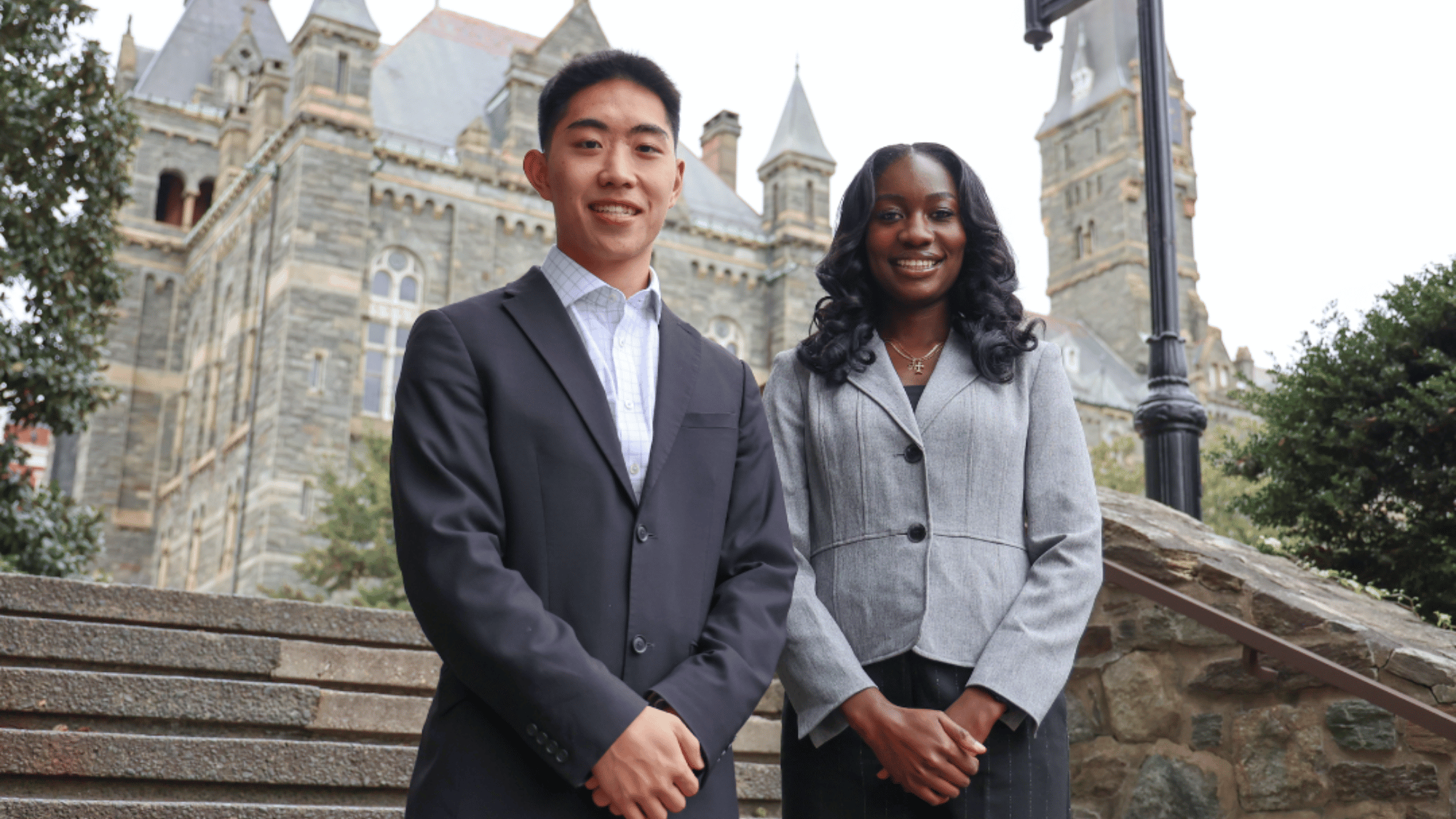 Photo of Jordan Pai and Kayla Wontumi standing on the Lauinger Library steps.