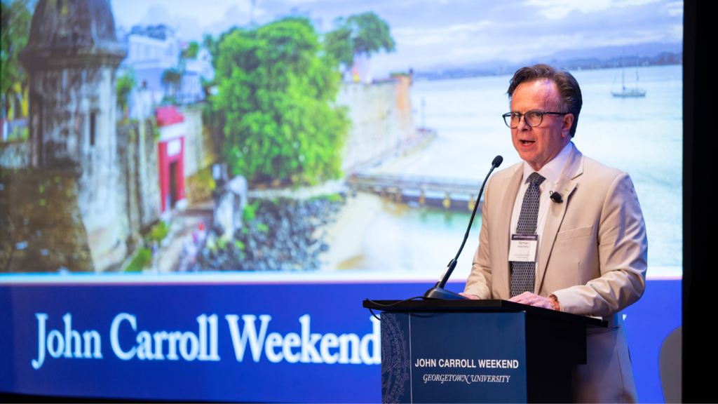 Norman J. Beauchamp Jr. speaking at a podium at John Carroll Weekend.